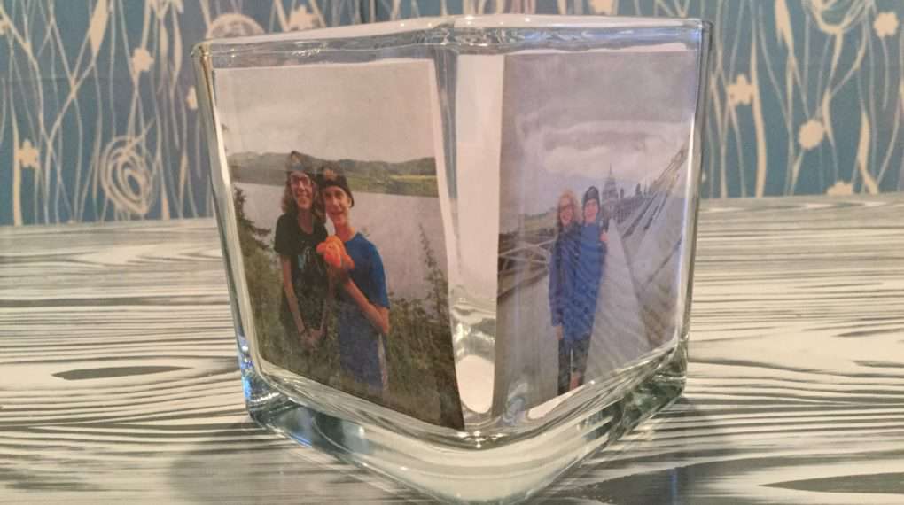 Continue to tape the photos into place on your candle holder. Use one photo or add as many photos as you like to your candle holder. Since mine is a square I place one on each side.