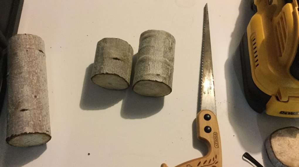 I guessed at the size I wanted my candle holders to be and I sawed them to size. After sawing them, I sanded the top and the bottom of the branches with a sanding block.