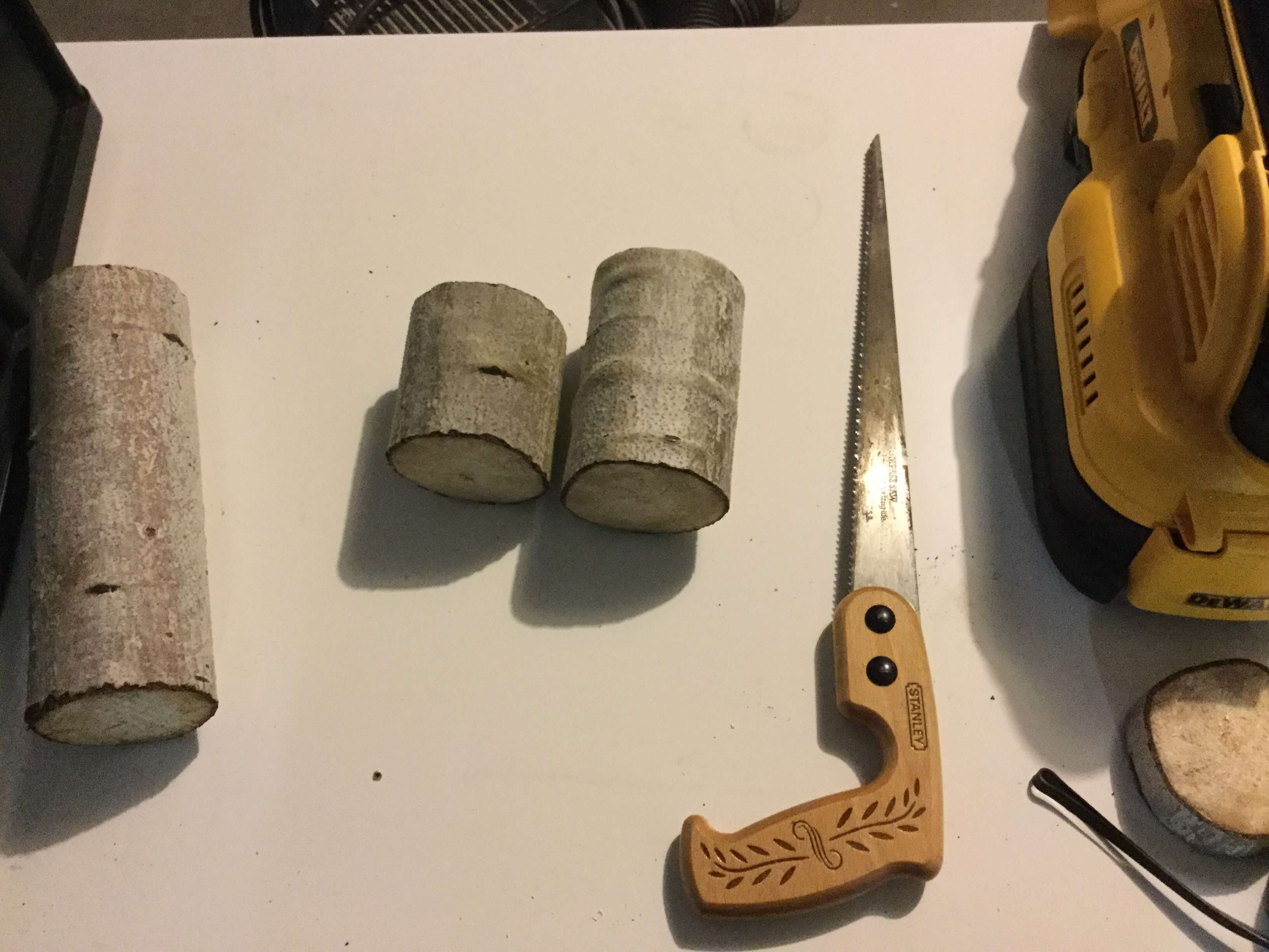 I guessed at the size I wanted my candle holders to be and I sawed them to size.  After sawing them, I sanded the top and the bottom of the branches with a sanding block.