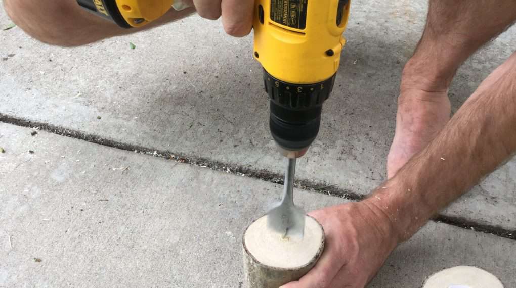 Using a 1 1/2 inch spade drill bit in our drill, we made indents for the candles.