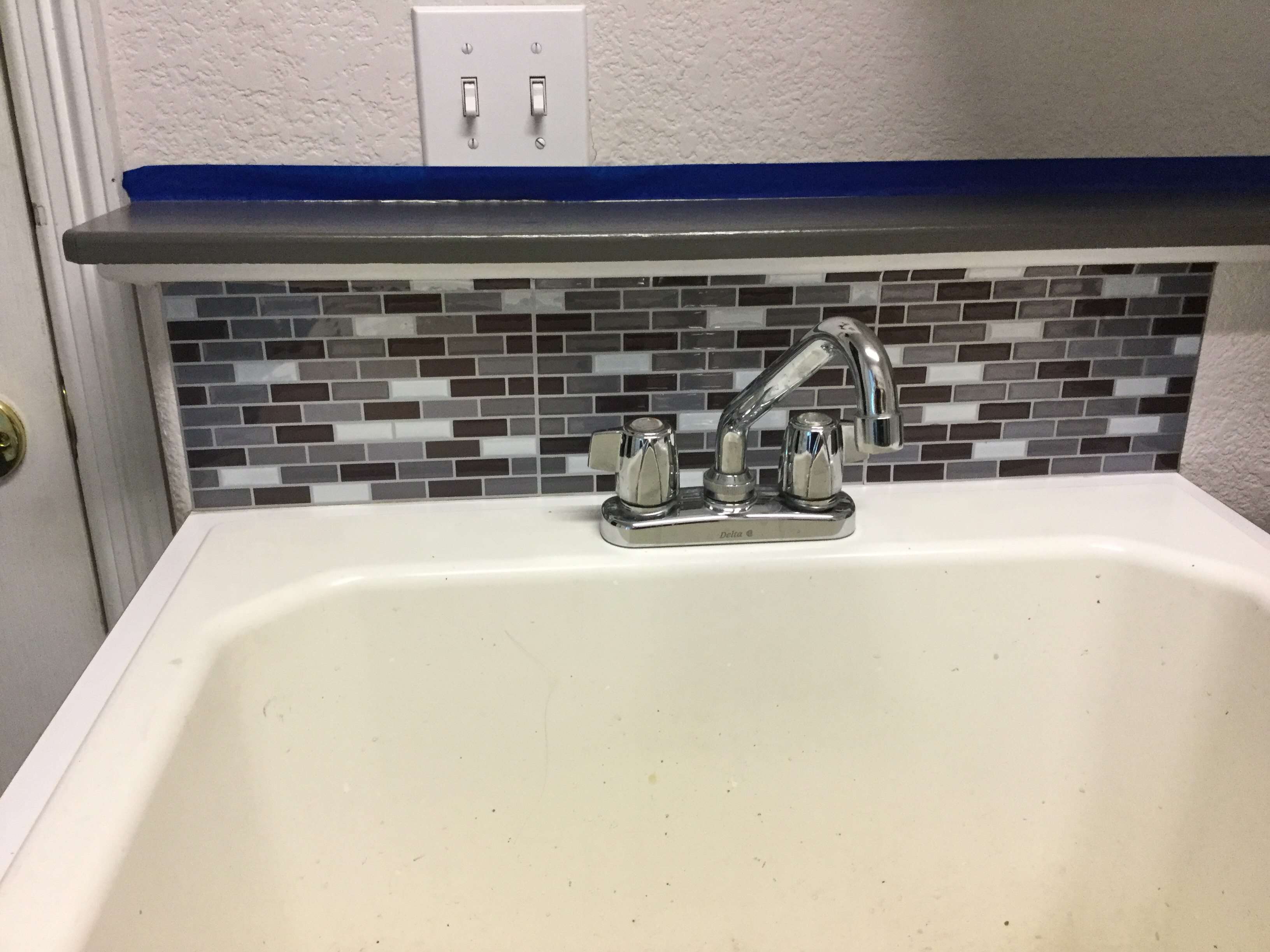 I added a peel and stick back splash to the laundry sink as well.