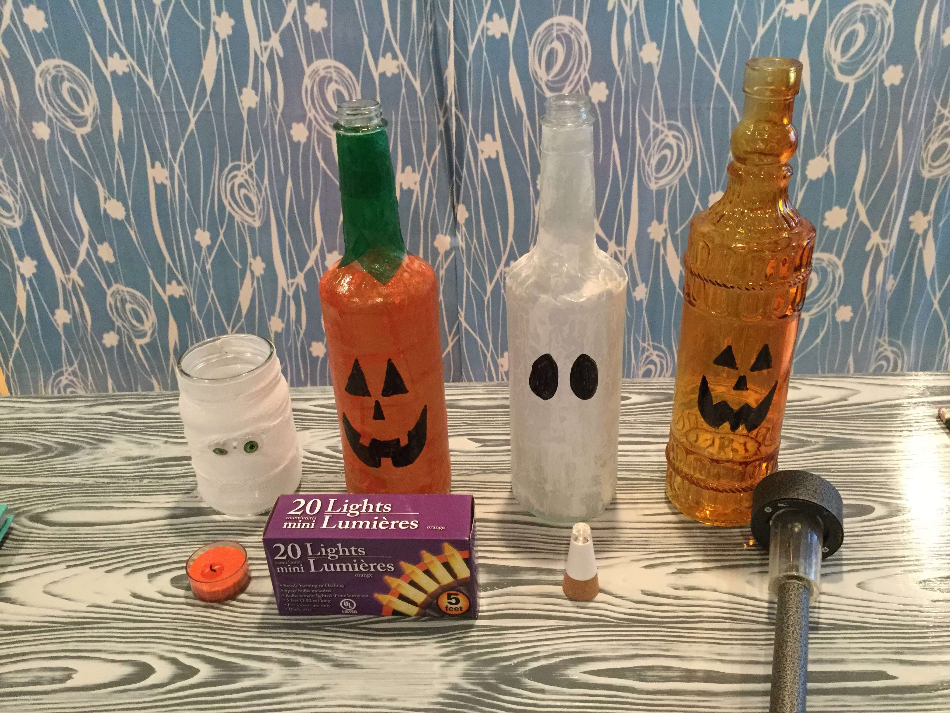 This is how I lit each of these projects - Mummy - tealight (or battery operated tealight) Mod Podge Pumpkin - 20 strand of orange lights Mod Podge Ghost - USB bottle light Orange Bottle Pumpkin - solar light