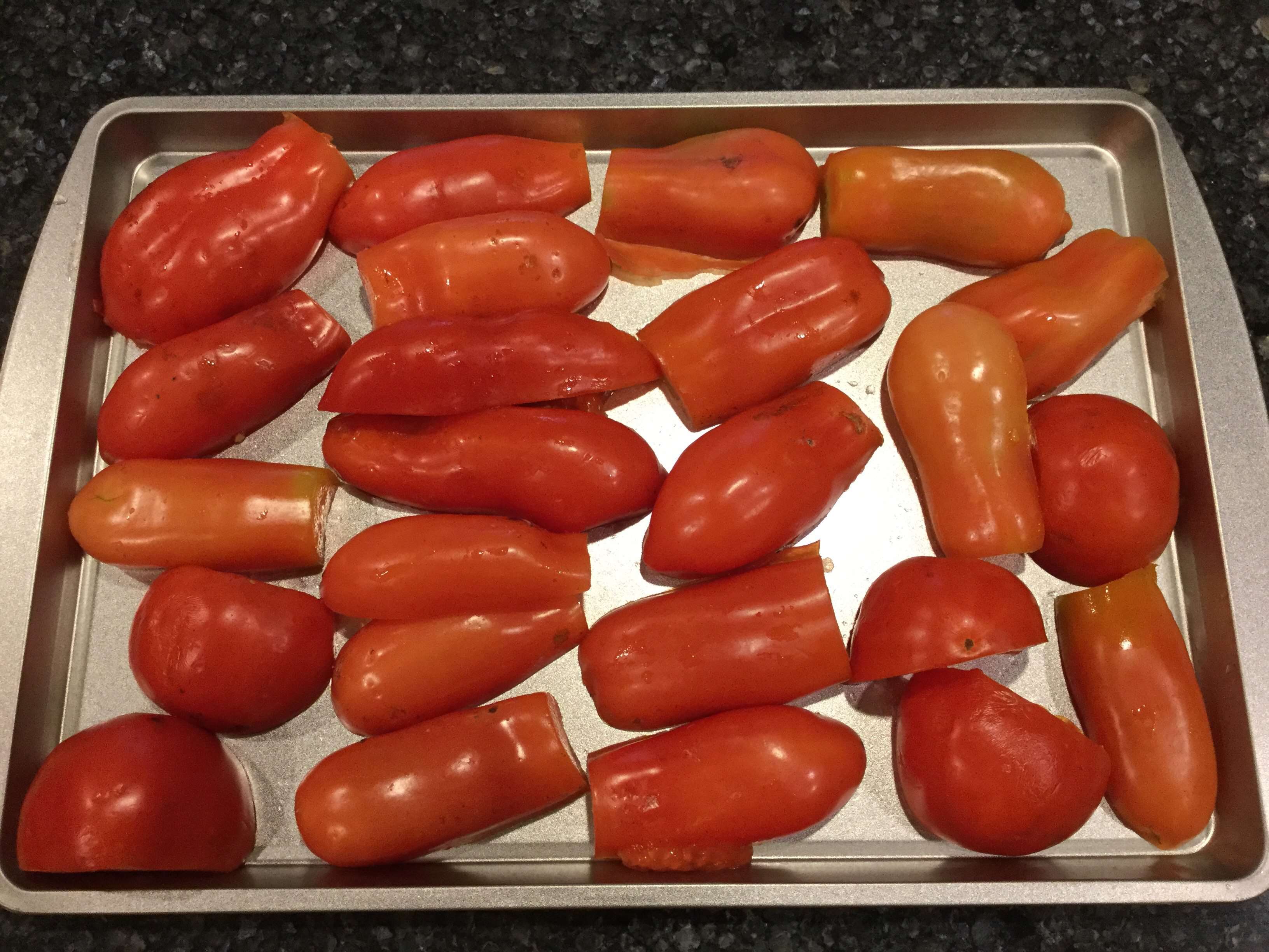 Cut these tomatoes in 1/2 and place in a single layer on a cookie sheet or two (or a pan of your choice).