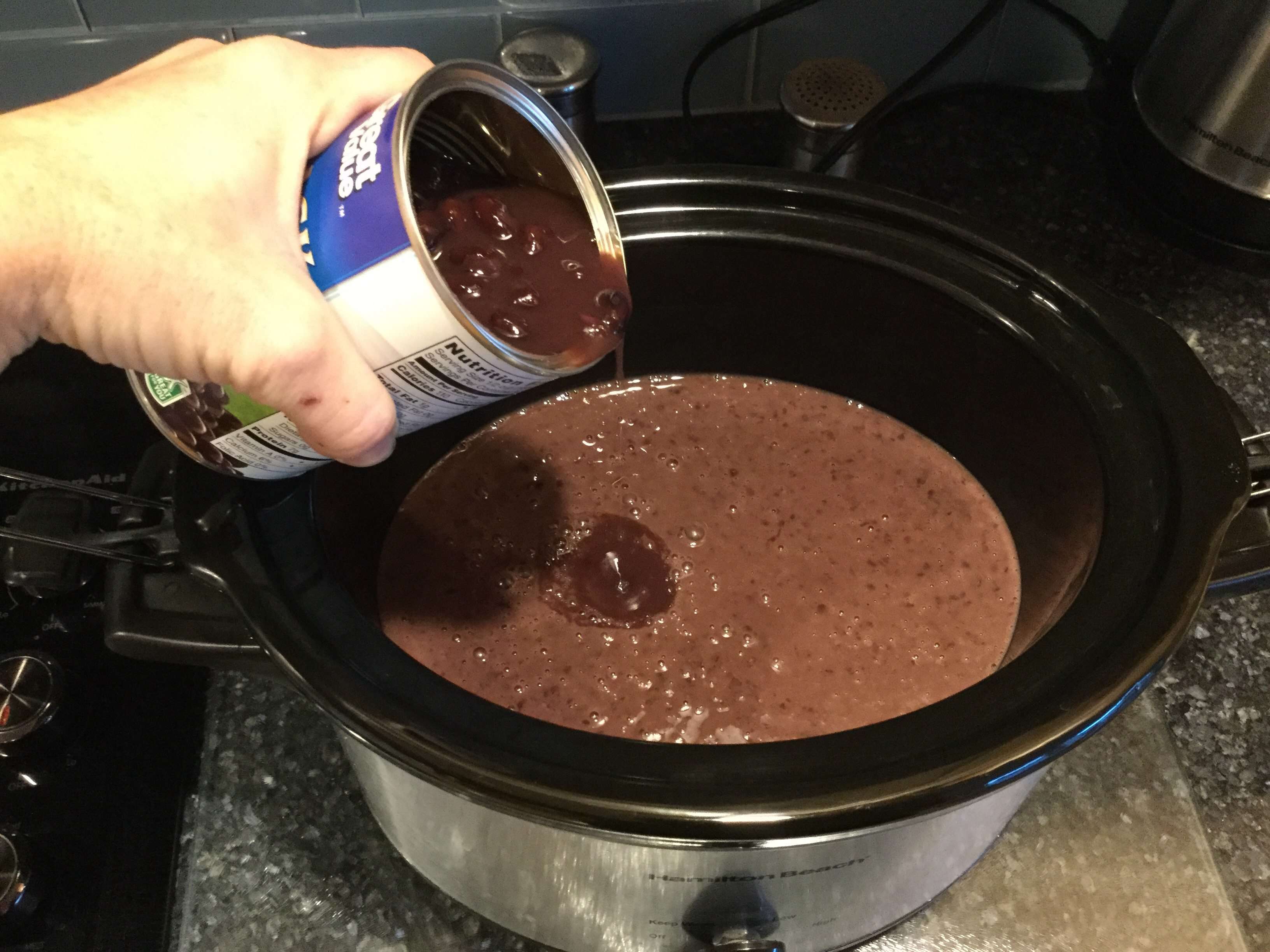 Pour mixture into slow cooker and add last can of black beans into the mixture.
