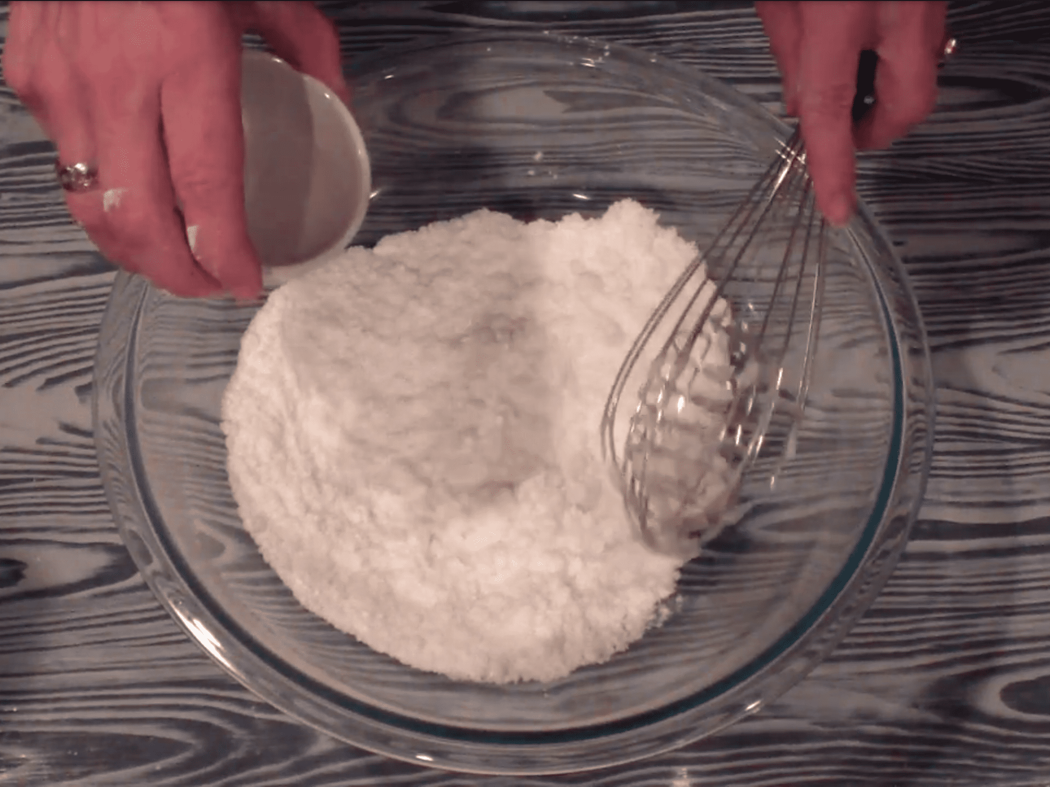 Whisking all the ingredients together until the mixture is evenly mixed together.