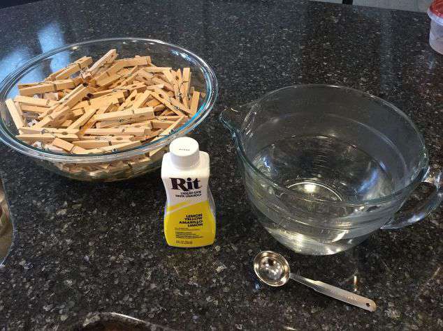 Cover the clothespins in water. Add 2 Tablespoons or more of Rit Dye to reach your desired color. Remember to shake the bottle up before pouring.