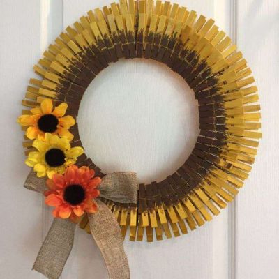 Tie a piece of twine at the top for hanging. Your clothespin sunflower wreath is done for you to enjoy.