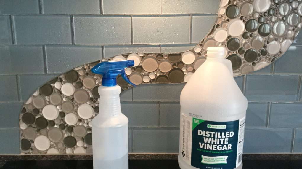 Pour your vinegar in the spray bottle. You can dilute it if you want, but don’t need to. The acidity in the vinegar will cut the grease and what will be disinfecting your back splash. Spray your back splash with the vinegar and wipe it down with a clean wash cloth (it’s important that it is clean or you will get streaks).