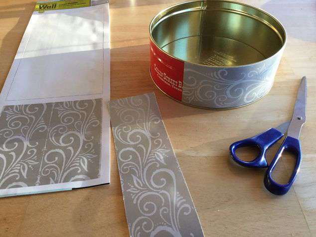 Use the wall sticker (mine came from Dollar Tree) to decorate the outside of the cookie tin. You could also glue on ribbon, or simply paint it.