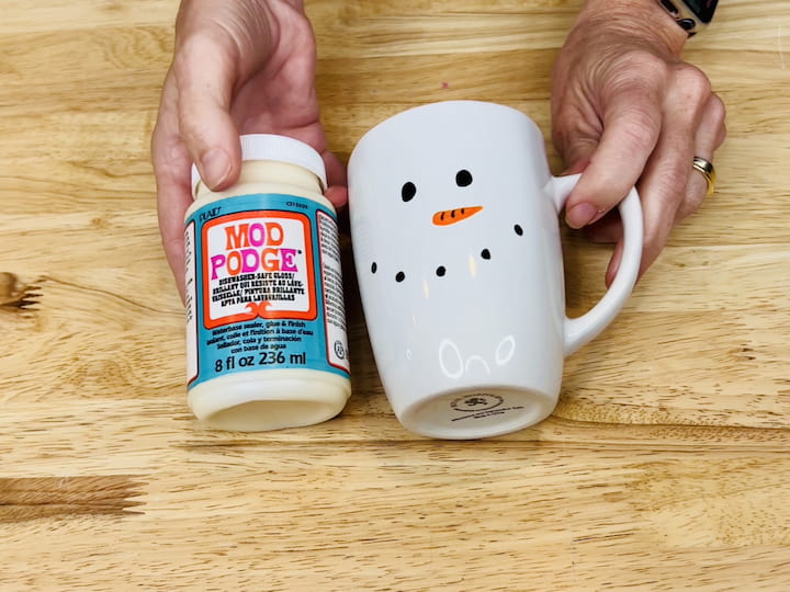 Step 8: Optional: Seal with Mod Podge If you want to preserve your snowman mug permanently, consider applying a couple of coats of dishwasher-safe Mod Podge. This step ensures the design stays intact even after washing.