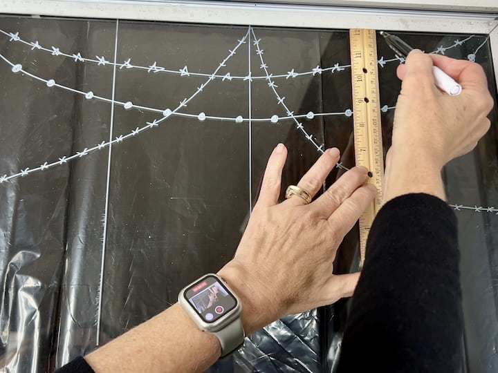 Step 2: Lay the Foundation Begin by drawing a bold line on the glass using your chalk markers. This line serves as the foundation for your creative masterpiece.