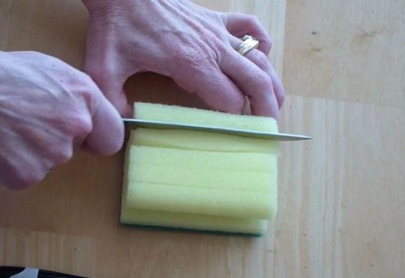 To clean a fan, you'll need to cut slices along your sponge.  This is to help the sponge fit between the rails on your fan.