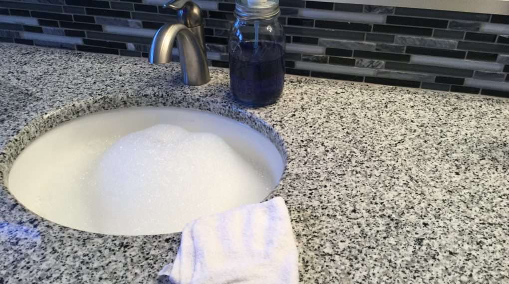 Make a sink of dish soap (like Castile or Dawn) and hot water. Use a clean and new wash cloth, dip in the clean soapy water, and wipe off all our counters and table. The key to streak free counters is the clean wash cloth with the clean soapy water - works every time! This is safe for granite counters.