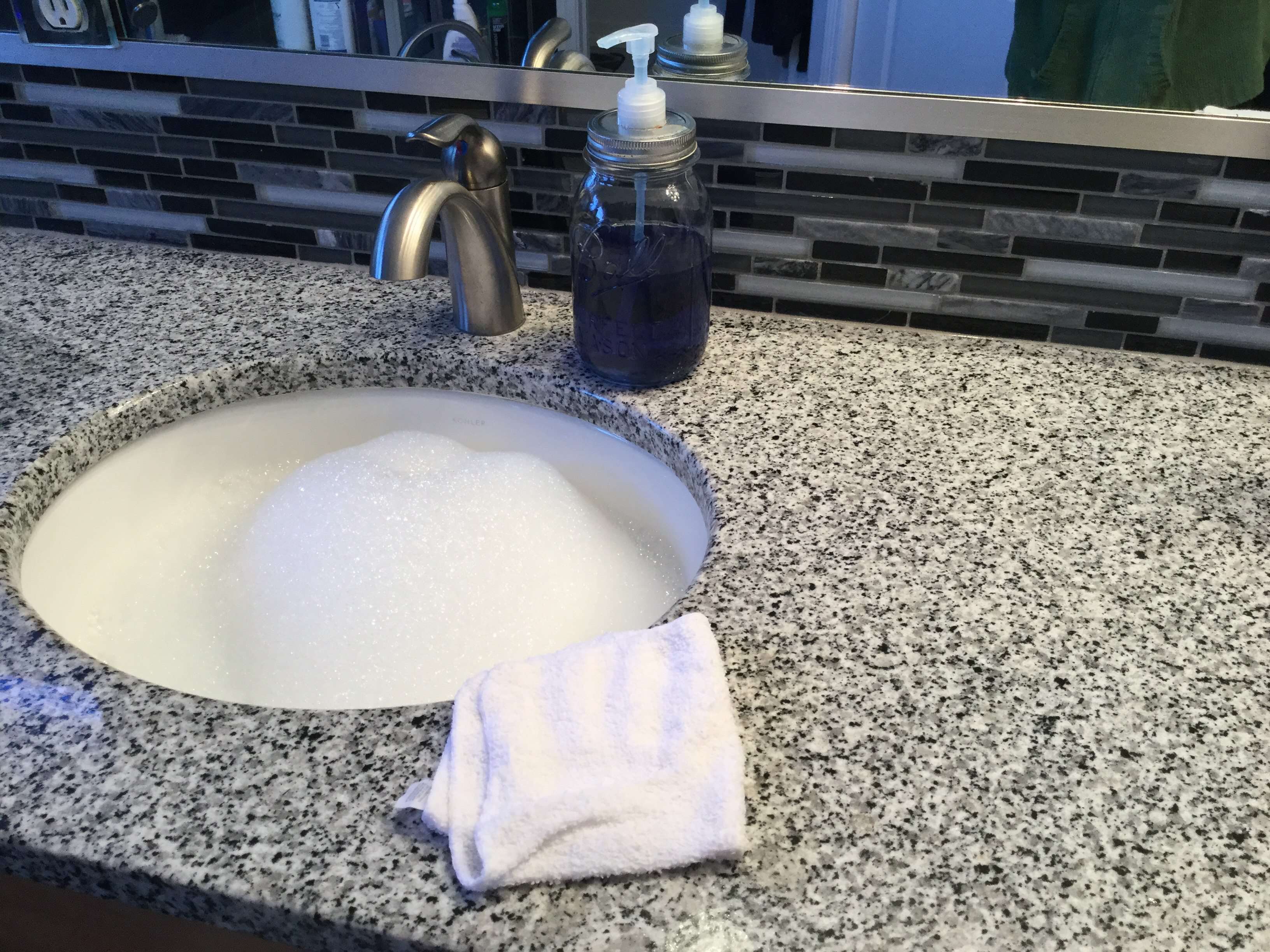 Make a sink of dish soap (like Castile or Dawn) and hot water. Use a clean and new wash cloth, dip in the clean soapy water, and wipe off all our counters and table. The key to streak free counters is the clean wash cloth with the clean soapy water - works every time! This is safe for granite counters.