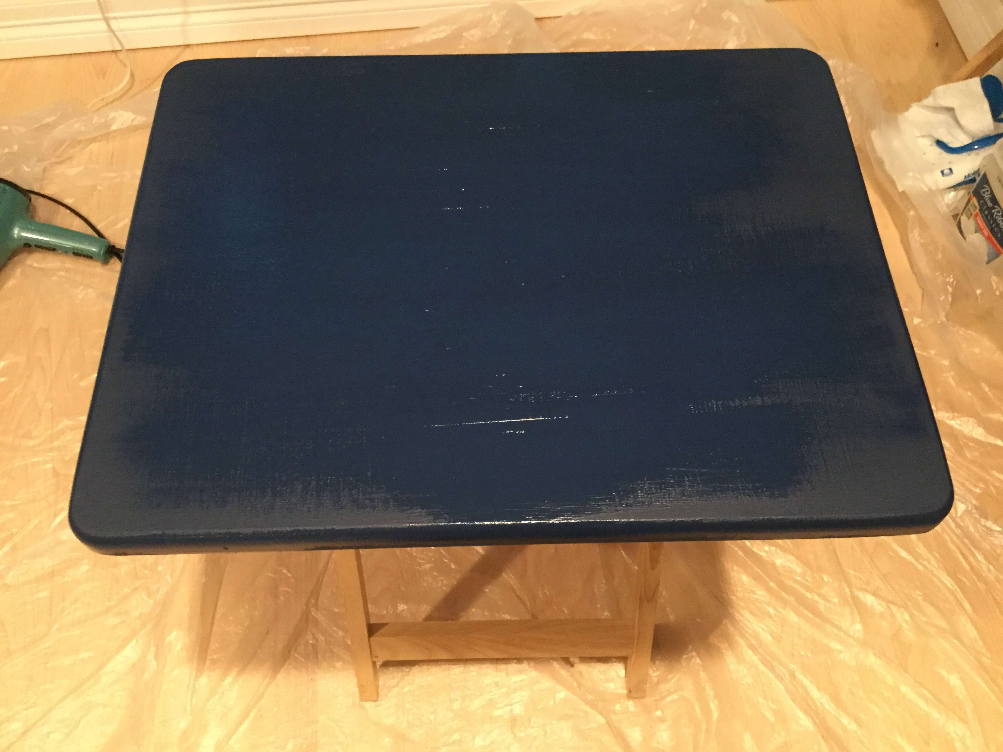 You're going to add 3 layers of Dixie Belle Paint and let it dry after each layer. I'll be using the Dixie Belle Bunker Hill Blue for this portion. You will put one coat on horizontal, the second coat you'll put on vertically, and the last coat you'll put on horizontally again. Let this dry completely.