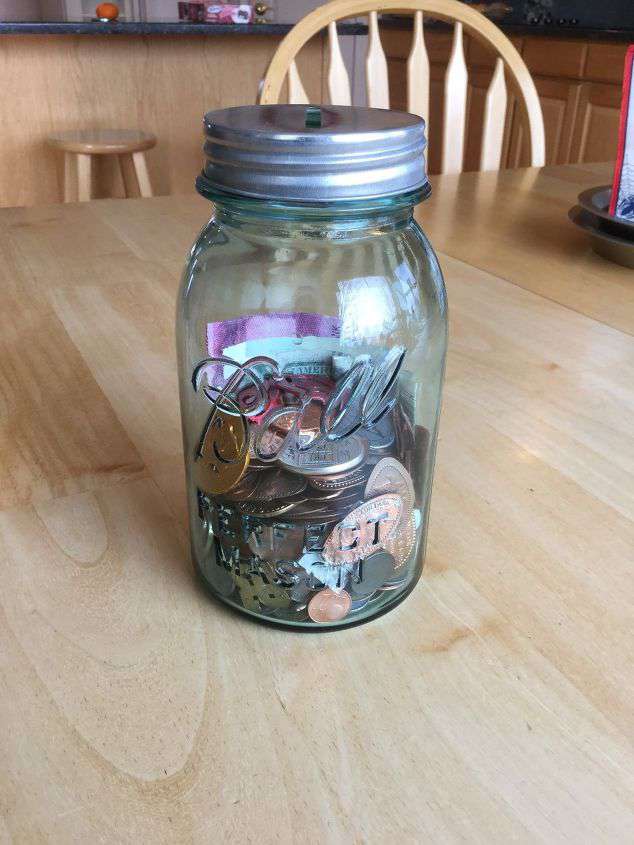 Turn it into a coin jar. (Mine is holding pressed pennies, collected souvenir coins, and money from other countries I’ve visited.   Buy a slotted lit or make a slot in your own lid.