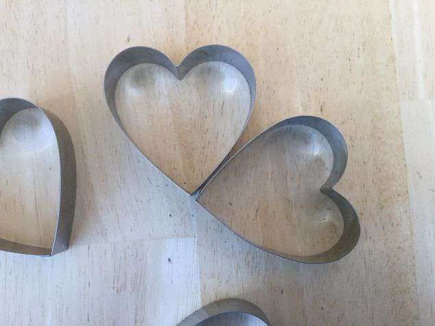 Stick 2 of the heart cookie cutters together.