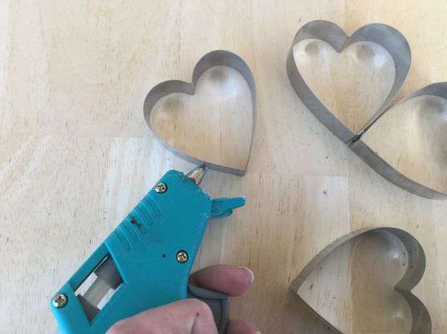 Add hot glue to another cookie cutter.