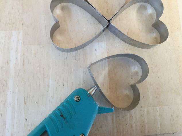 Add glue to both sides of the last cookie cutter.
