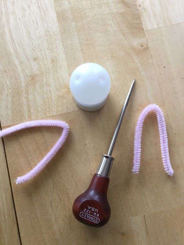 Cut your pipe cleaner in 1/2 and then fold each piece in 1/2.Poke 2 holes in the top of the ping pong ball.