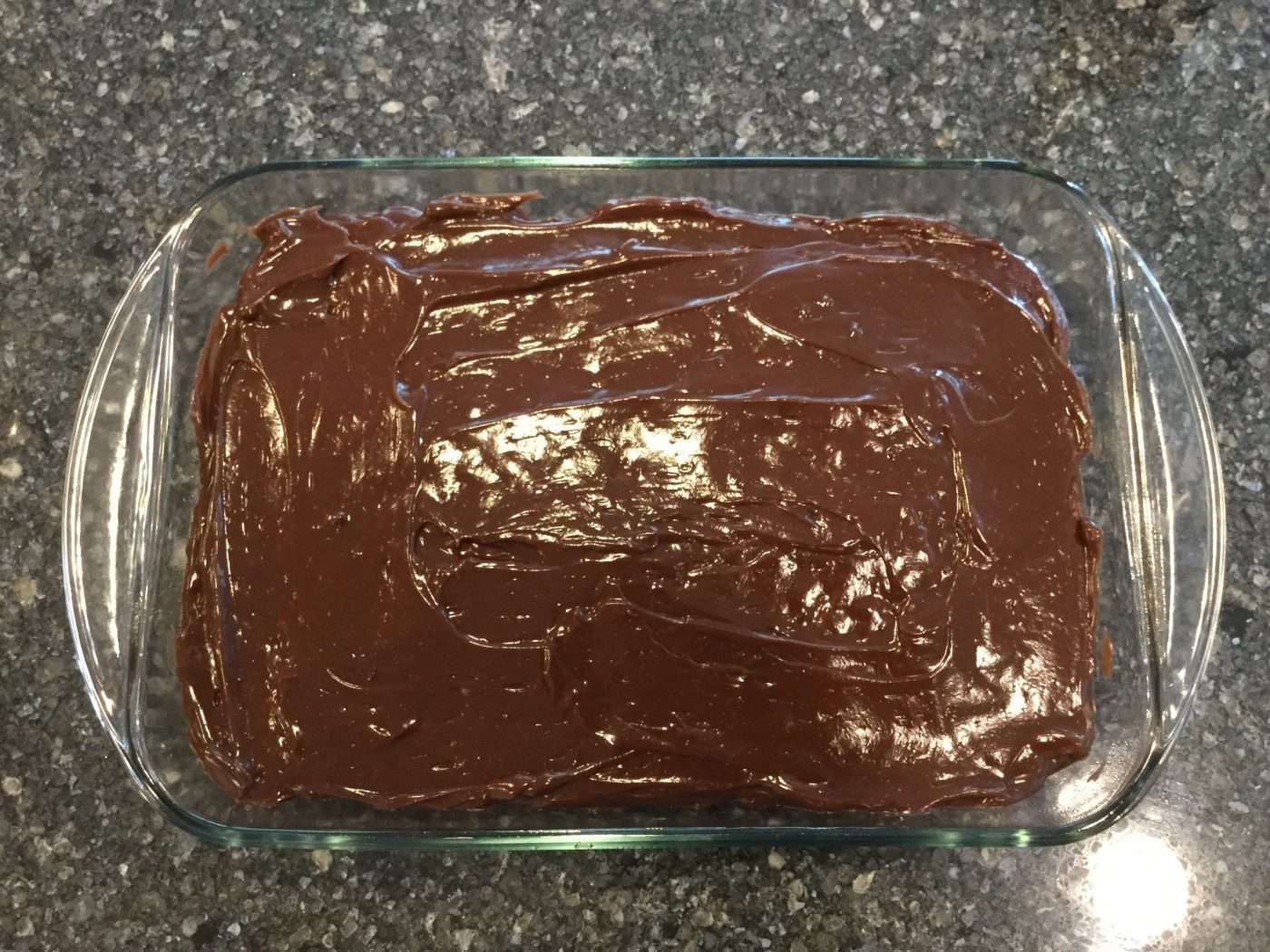 Spread the chocolate pudding on next and cover the cake completely.