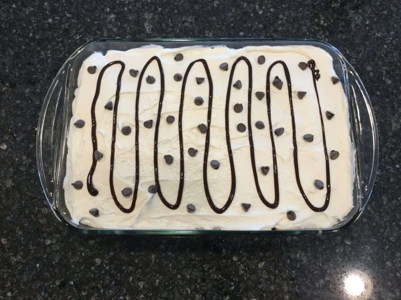Decorate the top with drizzled chocolate syrup, chopped chocolate (I used chocolate chips), or leave plain. The cake is ready to eat. If you are not eating it right away it is best to keep it in the refrigerator until ready to serve.