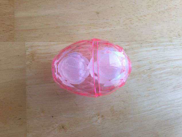 Place your plastic ice cubes into the plastic egg. Or your desired treat if not using it for “boo boos”. Close the egg.