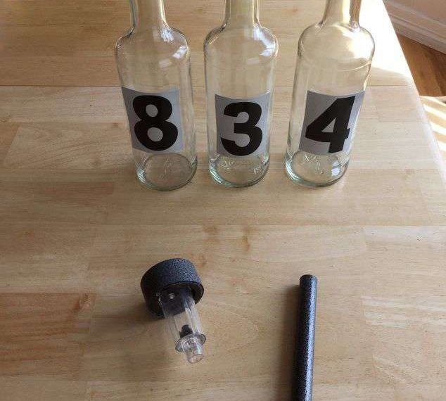 Place the reflective number stickers on the bottles. Pull the base off the solar lights.