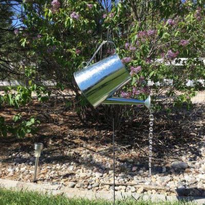 I put my yard stake out in my yard, and simply hung the watering can on it. Stake is 3 feet & the watering can is 8 inches.