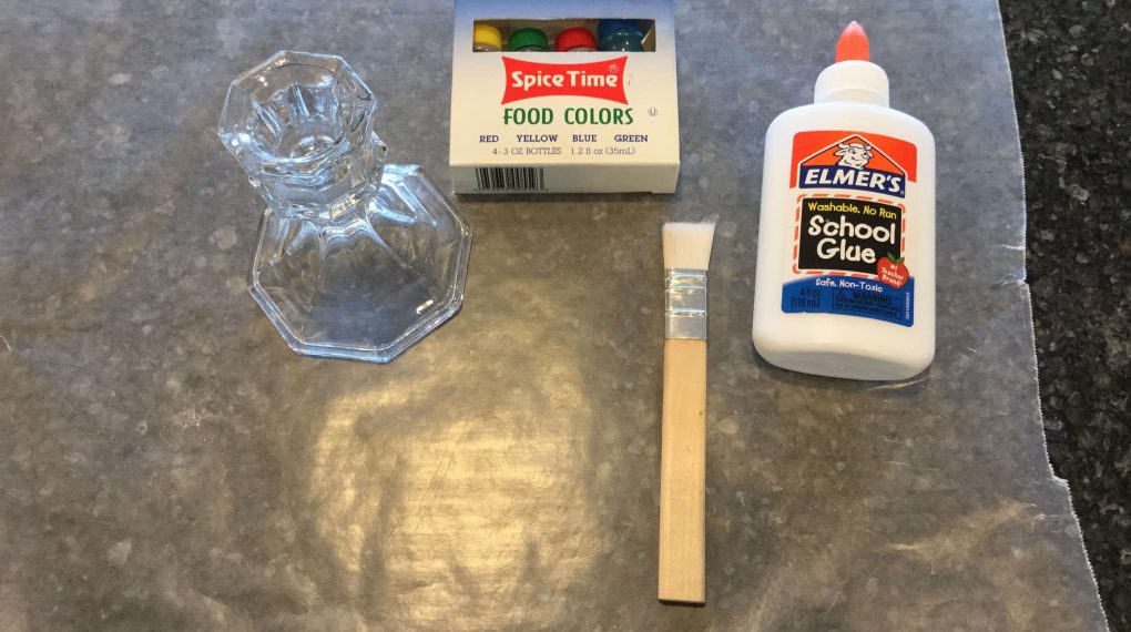 You'll need a candle holder, recycled jar, picture frame of your choice, school glue, food color, and a paint brush.