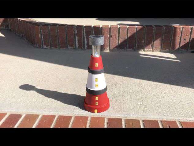 I made a lighthouse out of terra cotta pots. Paint the pots, silicone them together, and add a solar light on top.