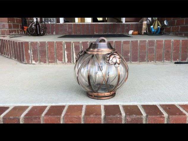 This is a glass pumpkin that I found at a thrift store.  I added a cylinder vase from Dollar Tree to the center and added a solar light to the top of it.