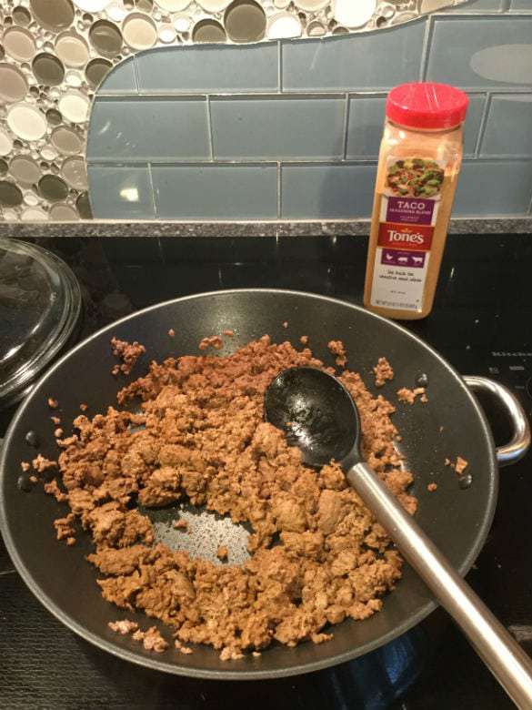 Brown your hamburger and we add taco seasoning to ours.  I follow the package instructions that tell you to add how much seasoning and water based on how much meat you are cooking.  You could change this to chicken, pork, or whatever you like.