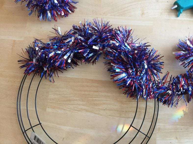 You will start winding the tinsel around the wreath form, adjusting as you go for tightness and space.