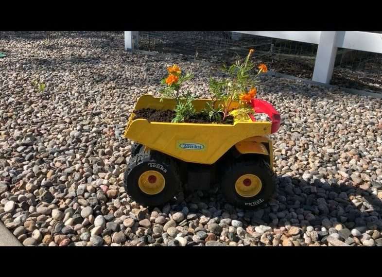 I planted some flowers in my son's old Tonka Truck. I added some dirt to the back and then planted the flowers in the it.