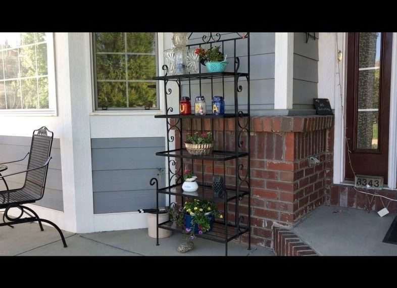 Here is my plant stand on my front porch. I planted flowers in a mini strainer, a tea pot, an old bunt pan, and you can see the blue pot on the bottom.