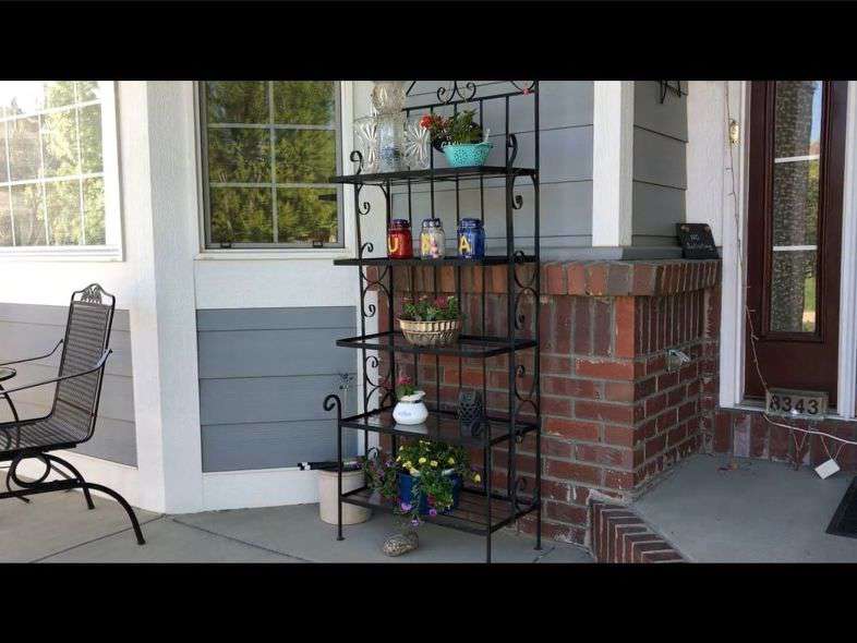 Here is my plant stand on my front porch. I planted flowers in a mini strainer, a tea pot, an old bunt pan, and you can see the blue pot on the bottom.