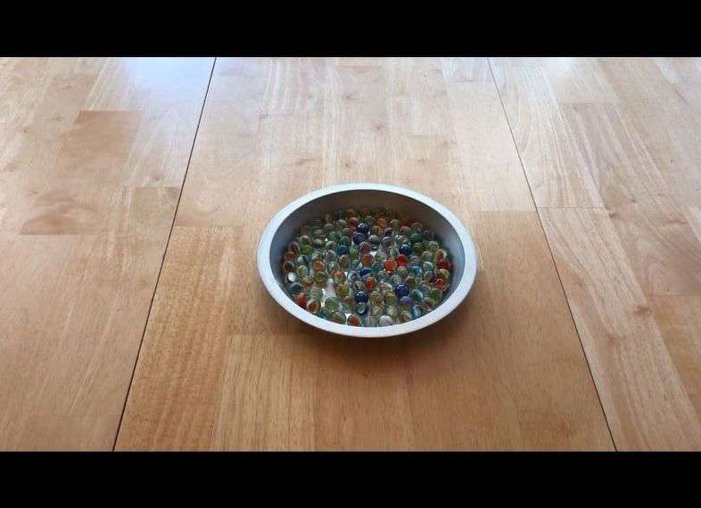Place 1 pie pan on your table and fill it with marbles.