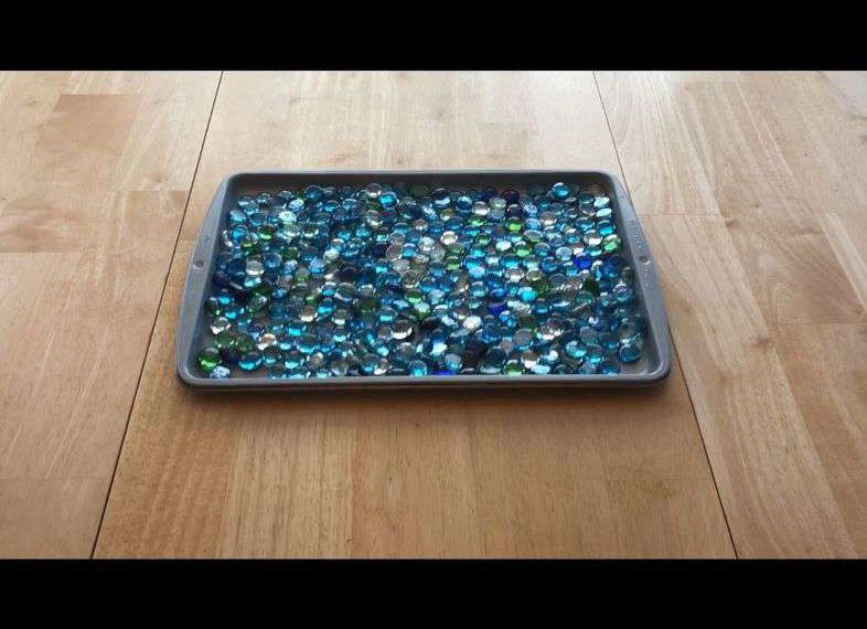 Fill a cookie sheet with dollar store rocks and place by your doo
