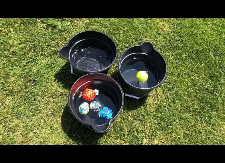 Place three of your buckets in a pyramid shape on opposite sides of your yard. You can decide how far apart you want to place them by the age of those playing. Add some water balls and it's up to you how many each player/team gets.