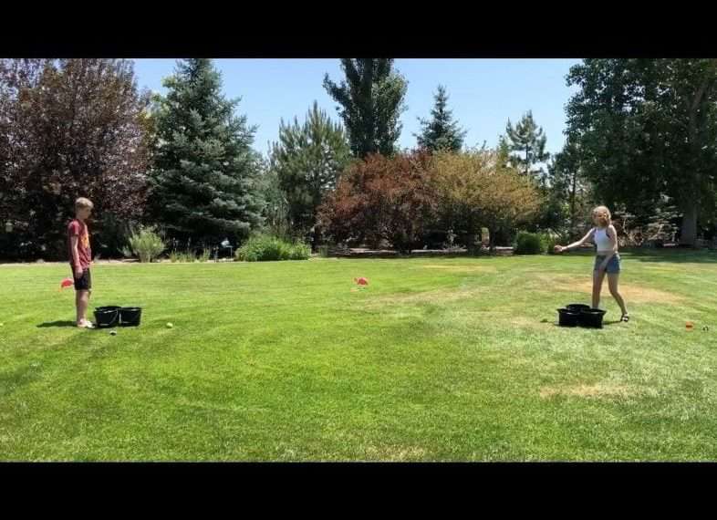 Take turns tossing the balls back and forth. If you land in an opponents bucket that bucket is removed. The winner is determined when all of their opponents buckets are removed.