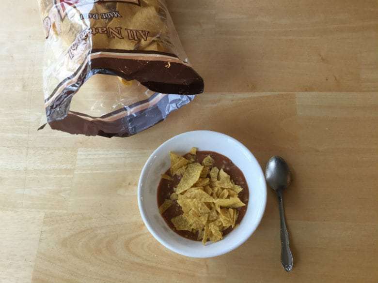Serve in bowls and top with crushed tortilla chips.