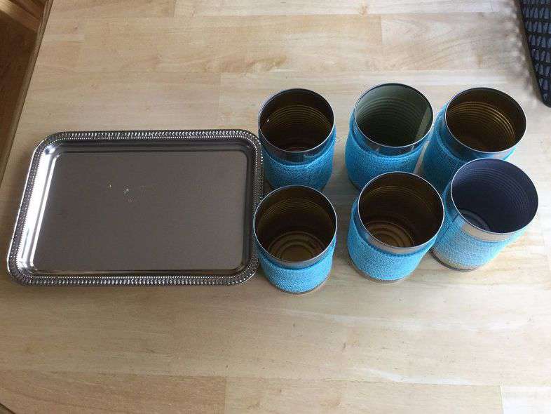The 3rd option - Place 6 cans on a small serving tray. If you want to secure them - hot glue them, use a magnet on the bottom, or use E6000.