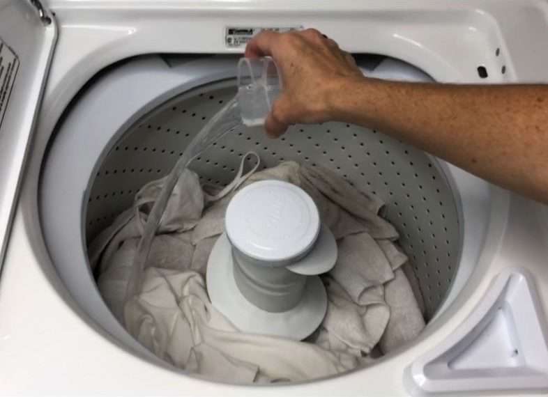 adding diy laundry hack cleaner to washing machine