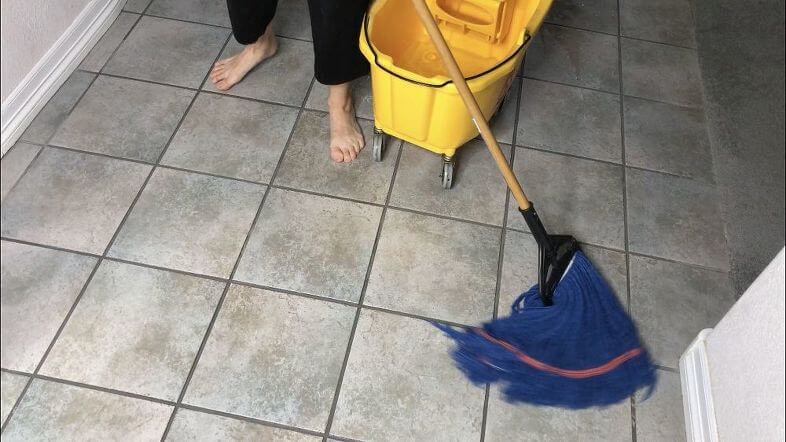 After scrubbing, mop with warm water rinse.