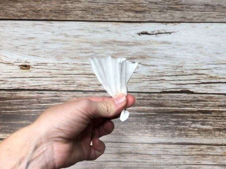 For most of these projects you'll take a coffee filter, place the center at the bottom, and squeeze up the filter to make a "flower" shape, and twist the bottom to hold in place.
