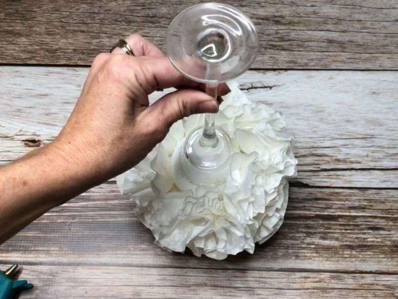 I hot glued on a candle holder from Dollar Tree to be the base. I then filled in any holes left with more coffee filters until I got it to be as full as I liked.