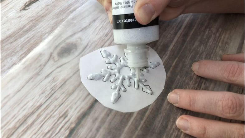 Window Cling - Use glittery fabric paint and squeeze out onto the wax paper tracing the snowflake underneath. Let it dry for 24 hours.