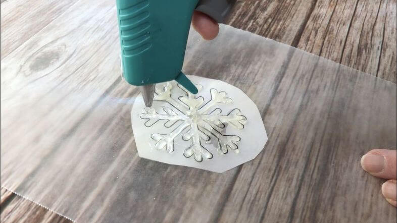 Regular Hot Glue Snowflake - spruced up Again - coat your wax paper as instructed above. Squeeze your hot glue onto the wax paper tracing the design of the snowflake. Let it cool completely.