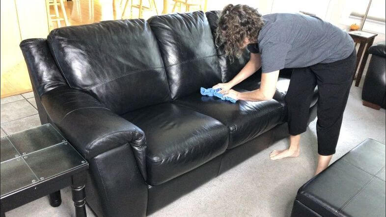 I use a damp microfiber cloth and wipe down the whole couch. I use a Norwex Envirocloth.